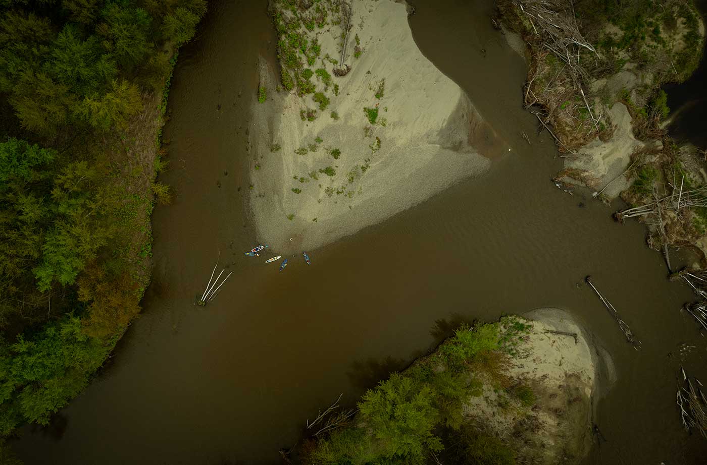 aerial view of paddleboarders and kayakers on river