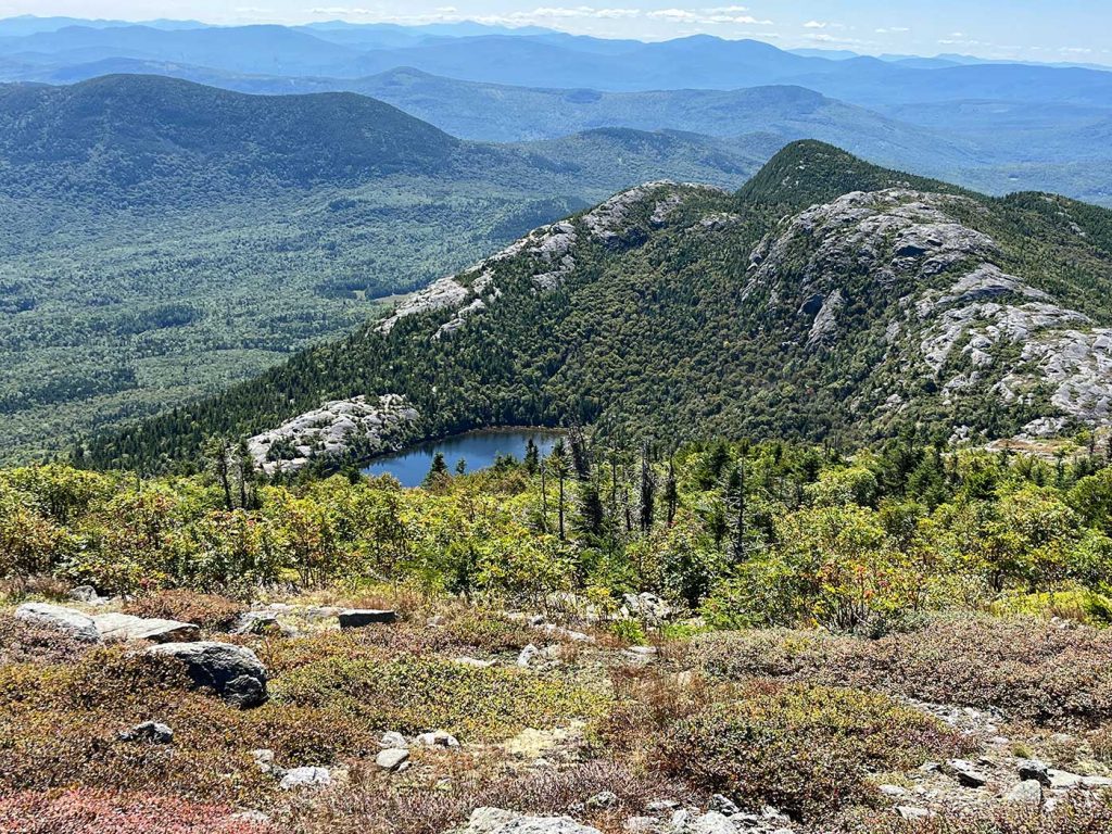 view of pond on top of mountain, with views behind