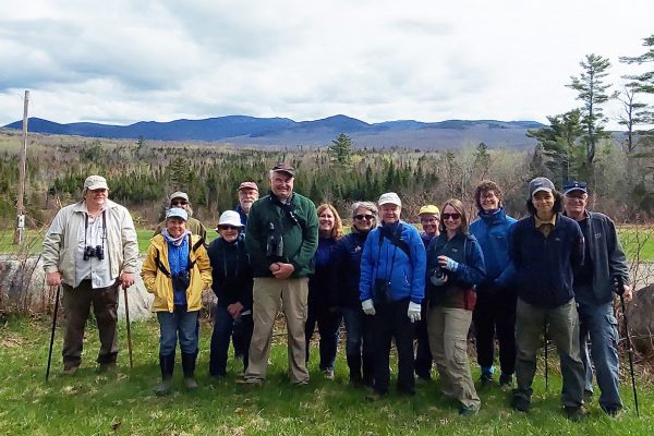 people standing outside with mountain in background