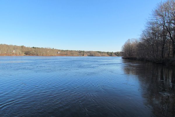 river underneath bright blue sky