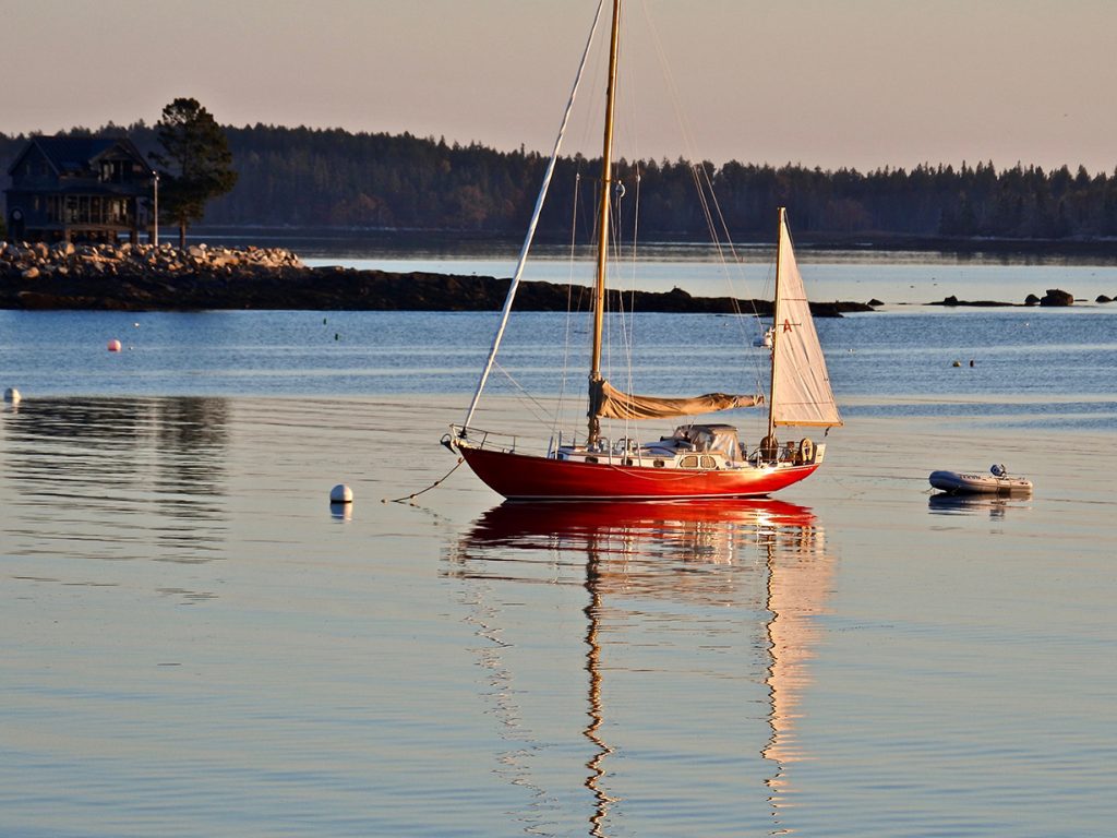 sailboat floating in calm ocean