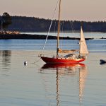 sailboat floating in calm ocean