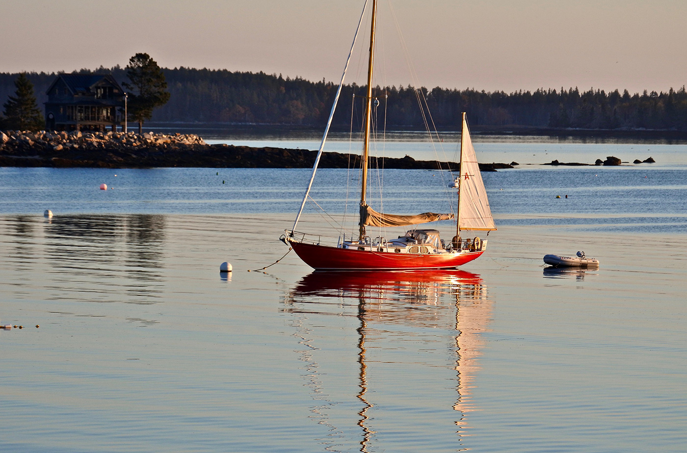 sailboat floating in calm ocean