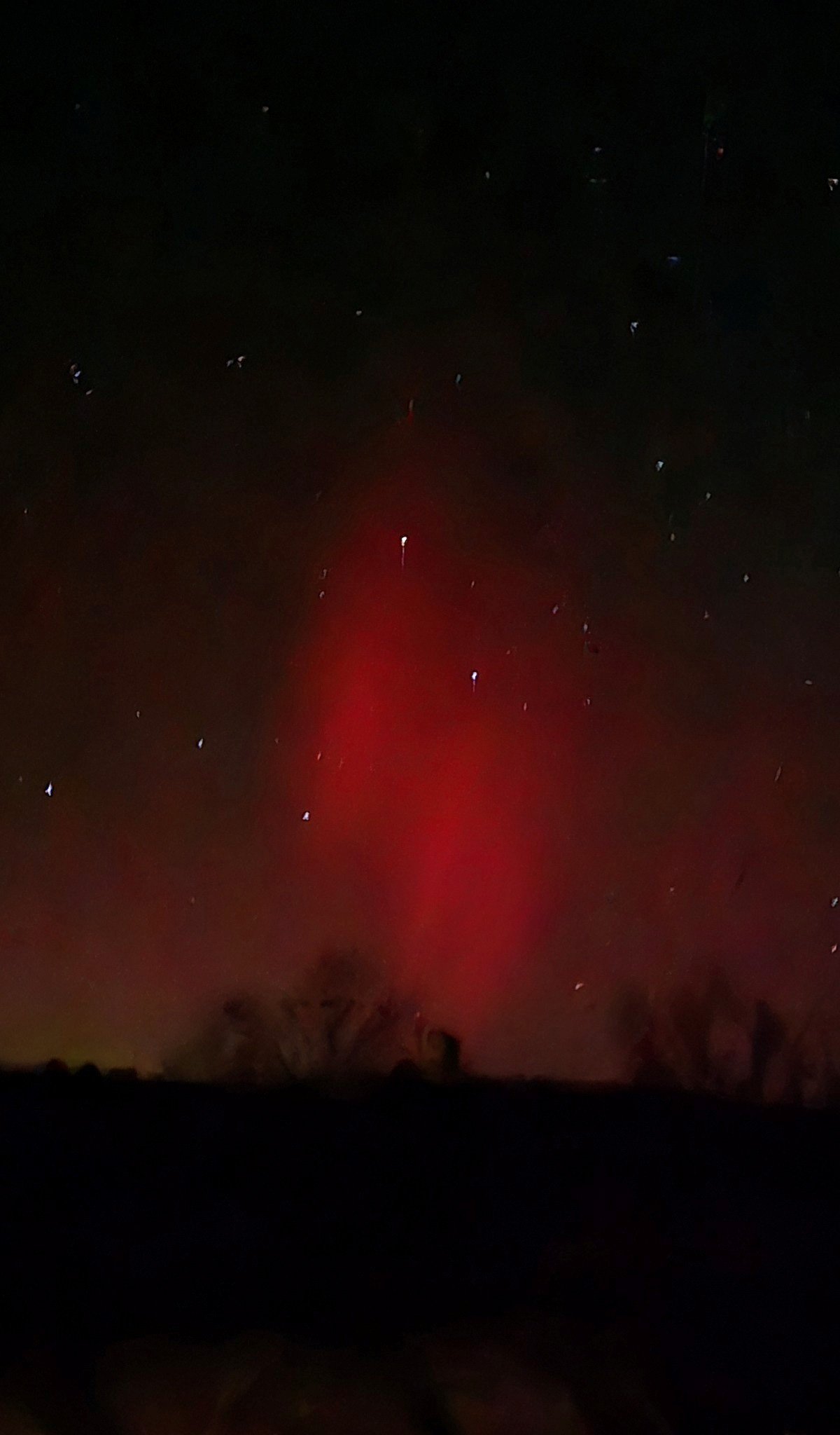 reddish northern lights in night sky