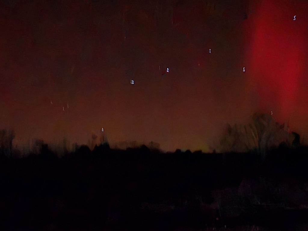 reddish northern lights in night sky