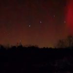 reddish northern lights in night sky