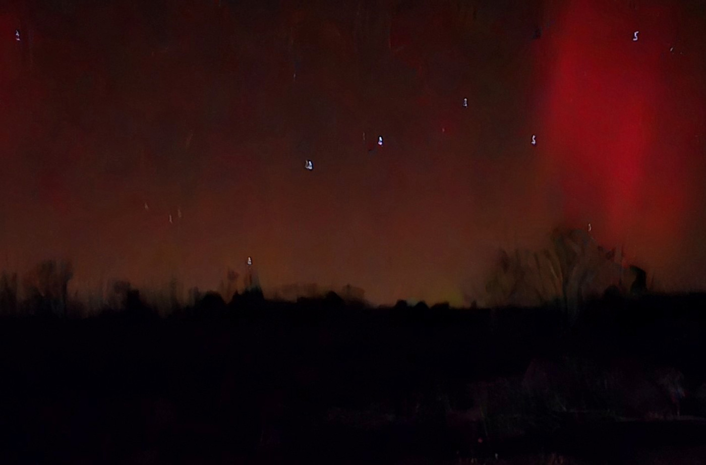 reddish northern lights in night sky