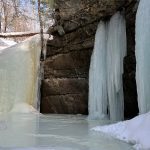 frozen waterfall down to frozen pond