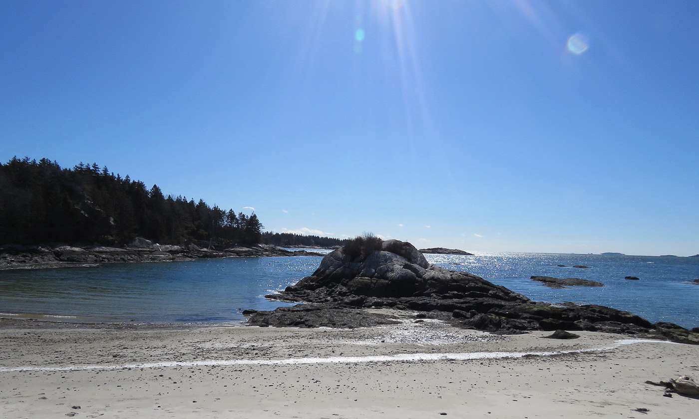 View of blue sky and sunshine from sandy beach